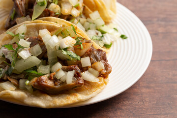 Three Delicious Buche Street Tacos in a Row on a Wooden Table