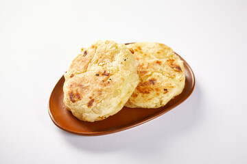 Wall Mural - Tortilla de yuca a traditional Ecuadorian appetizer served with coffee. It’s on a white background.