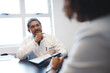 © Arnéll K/peopleimages.com - If youve got a medical concern, hes there to listen. Shot of a mature doctor having a consultation with a patient in his office.