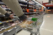 © 1000 Words - Shopper pushes a cart in supermarket aisle - image has shallow depth of field with intentional soft focus