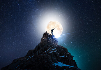 Wall Mural - Silhouette of a person on the rock in starry night sky and full moon.  Bright milky way galaxy behind him.