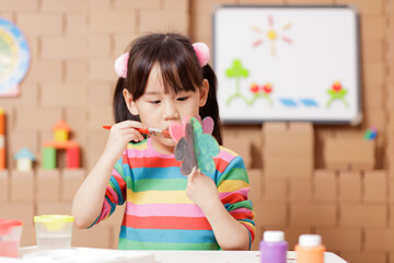 young girl hand make craft for home schooling