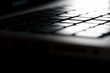 © Panithan - close up notebook keyboard in the spot light. Background for coding and computer
