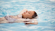 © Mariusz S/peopleimages.com - Like floating on a cloud. Cropped shot of a beautiful young woman relaxing in a swimming pool.
