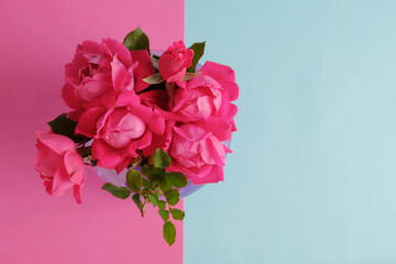 Sticker - Top view of roses in bouquet on pink and blue background with copy space for mothers day holiday.
