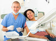 © JackF - Portrait of satisfied woman visiting dentist giving thumbs up in the dental clinic