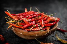 A Full Plate Of Dried Chili Peppers. On A Black Background. High Quality Photo