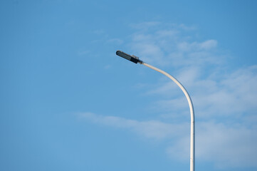 LED street lights lit under the blue sky