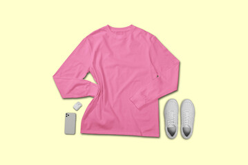 Pink long sleeve t shirt top view with creative flat lay concept