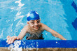 © Marcos - latin child boy swimmer wearing cap and goggles in a swimming training at the Pool in Mexico Latin America