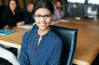 © D Laflor/peopleimages.com - Believing in yourself is the first secret of success. Portrait of an office worker in a meeting with colleagues in the background.