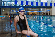 © Marcos - hispanic teenager girl swimmer athlete wearing cap and goggles in a swimming training at the Pool in Mexico Latin America