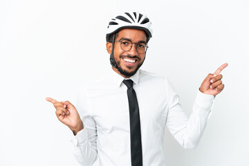 Wall Mural - Young business latin man holding a bike helmet isolated on white background pointing finger to the laterals and happy