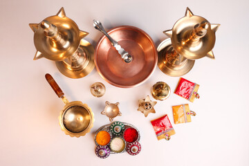 Indian traditional samai or samayee brass lamp, puja thali with includig kalash agarbatti
diya dhup samai agarbatti holder kunku sindoor or Kumkum turmeric haldi or halad on white background