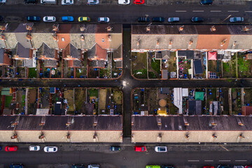 Wall Mural - Aerial bird's eye view of the rooftops of terraced houses and back yards in a Northern UK city