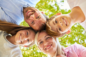 Wall Mural - Parents and children as a happy family in summer