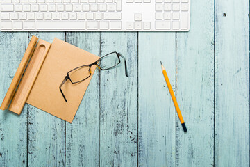 Wall Mural - keypad, eyeglasses, recycled note paper on blue wooden table, top view