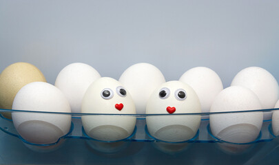 Wall Mural - There are white eggs on the shelf in the refrigerator. One egg has a cute face