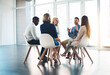 © Arnéll K/peopleimages.com - Putting their minds to work. Full length shot of a group of corporate colleagues meeting in their office.