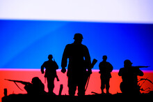 War In Ukraine. Russia Attack Ukraine. Illustration Photo. Silhouette Of Soldiers, National Flag In Background. Conflict In Europe