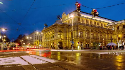 Wall Mural - Vienna, Austria. Night view of State Opera in Vienna, Austria during the snowy winter. Blue dark sky, car traffic. night time-lapse