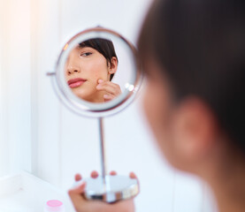 Sticker - Where did you come from. Shot of a stressed out attractive young woman noticing a zit on her face while looking at her refection in a mirror at home during the day.