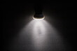 Blank concrete wall illuminated by a modern wall lamp. Closeup photo with copy space
