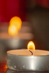 Poster - Candle lit on wood during holy week in Seville