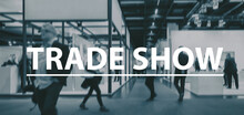 Blurred Business People Walking On A Trade Show - Text Concept I