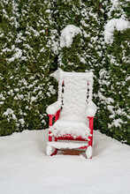 Single Lawn Chair Covered In Snow On A Deck
