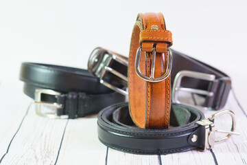 Wall Mural - brown belt for men or women, rolled up, on top of other belts