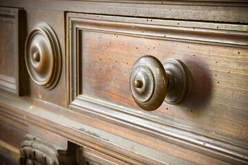 Detail of an old knob turned wood with wooden surface and small holes damaged by woodworms - Old Tuscany furniture - Italy, 19th century