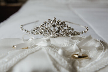 Canvas Print - Close-up shot of a wedding crown on a white fabric.