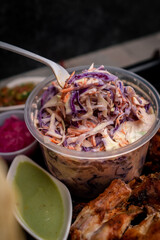 Poster - Colorful cabbage salad in a transparent plastic bowl