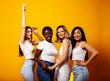 © iordani - diverse multi nation girls group, teenage friends company cheerful having fun, happy smiling, cute posing on yellow background, lifestyle people concept, african-american, asian and caucasian