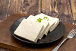 © enezselvi - Sliced Feta cheese with herbs on wooden background. Close-up breakfast cheese