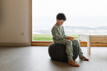 Boy In Pajama Playing On Smartphone