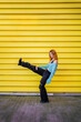 © ADDICTIVE STOCK - Trendy woman raising leg on street