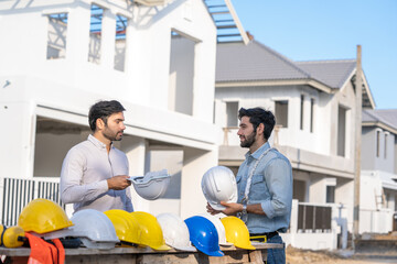 Fototapete - Architect,Foreman and worker discussing in building construction site in construction site,Construction residential new house in progress at building site.