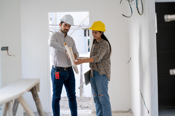 Fototapete - Architect,Foreman and worker discussing in building construction site in construction site,Construction residential new house in progress at building site.