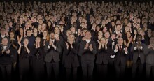 Front View Of Spectators Wearing Formal Attire Delivering Standing Ovations. Crowd Background For Theater, Opera, Ballet
