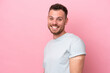© luismolinero - Young Brazilian man wearing a band-aids isolated on pink background smiling a lot