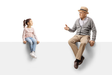 Wall Mural - Gentleman sitting on a blank panel and talking to a child