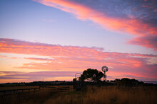 Windmill Sunset At An Australian Farm. The Red Sky