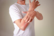 Man scratching itch with hands on the back of the hand / itching and skin problems / Health and medical care