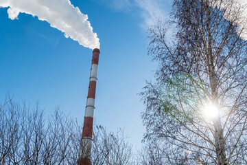 Industrial smoking pipes close up of various types of thermal power stations in winter. Selective focus.