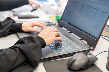 Woman's hands working with a computer