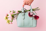 Fototapeta  - Fashion spring accessories - mint handbag (purse) and heart shaped sunglasses on pastel pink.