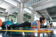 © CandyRetriever  - Healthy Asian athlete woman in sportswear do plank workout exercise body weight lifting at fitness gym. Strong female body building muscle weight training at sport club. Health care motivation concept