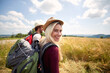 © luckybusiness - Hiker woman smilling and walking in field with a man, nature outdoor. Sport, freedom, holiday concept.